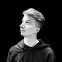 A monochrome photo of a person on a dark background